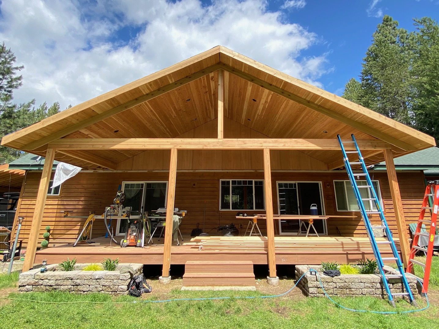 This is a back wooden deck, covered with a new roof overhead with tongue and groove cedar wood in sandpoint idaho.