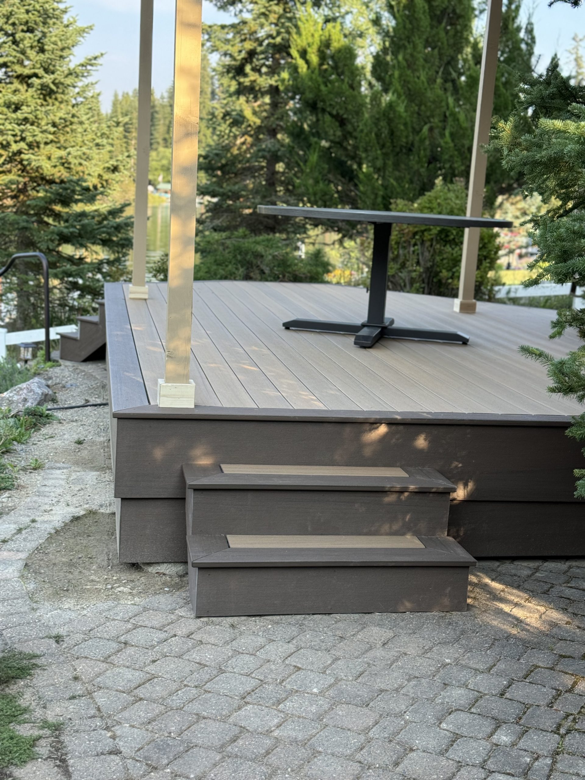 Back view of deck made of treks decking, composite decking, with steps and a table, located in sandpoint idaho.