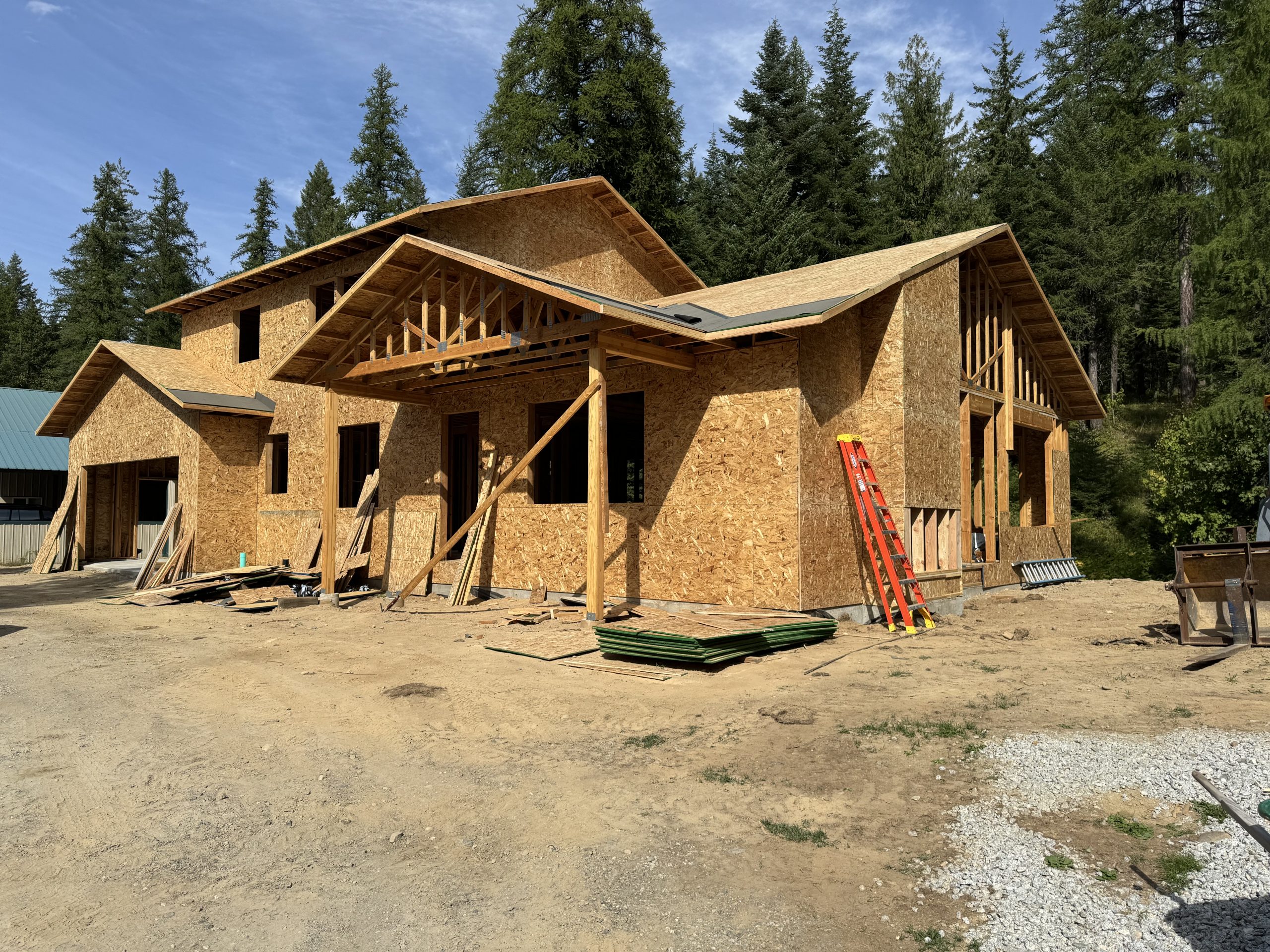 This is a two story constuction house with framing being built in the forest in sandpoint idaho.