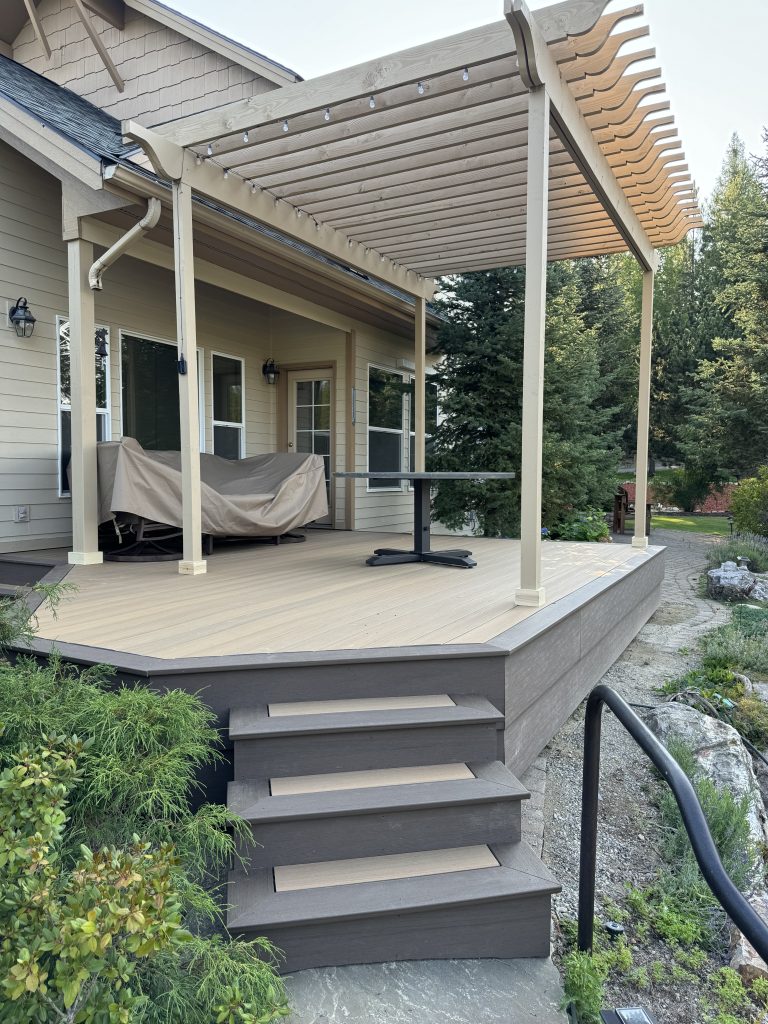 Back deck with treks decking, covered by a pergola, with steps and railing, in sandpoint idaho