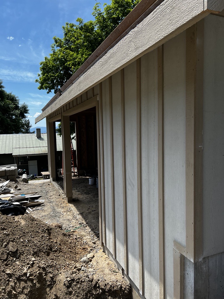 House with Garage Doors and Siding with Board and Batten and Facia